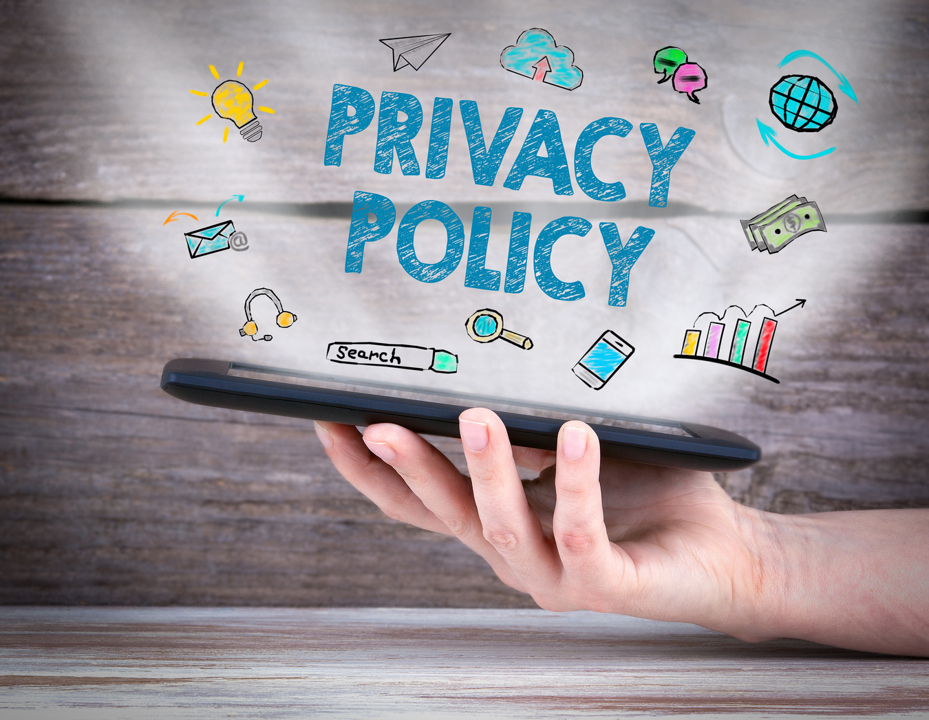 privacy policy. Tablet computer in the hand. Old wooden background